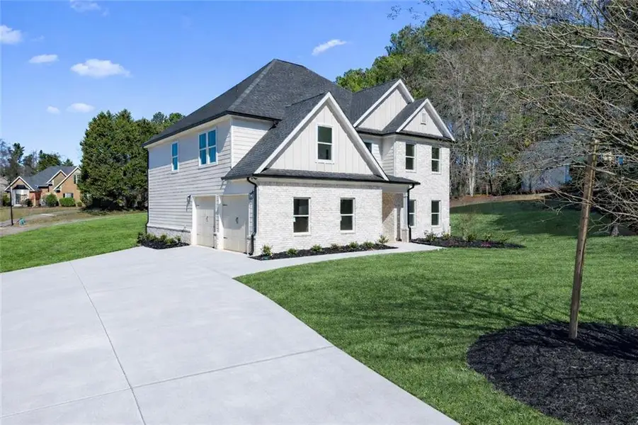 Front exterior of a new home in , Stockbridge, GA, highlighting curb appeal (Image 2). Front exterior of a new home in , Stockbridge, GA, highlighting curb appeal (Image 2).