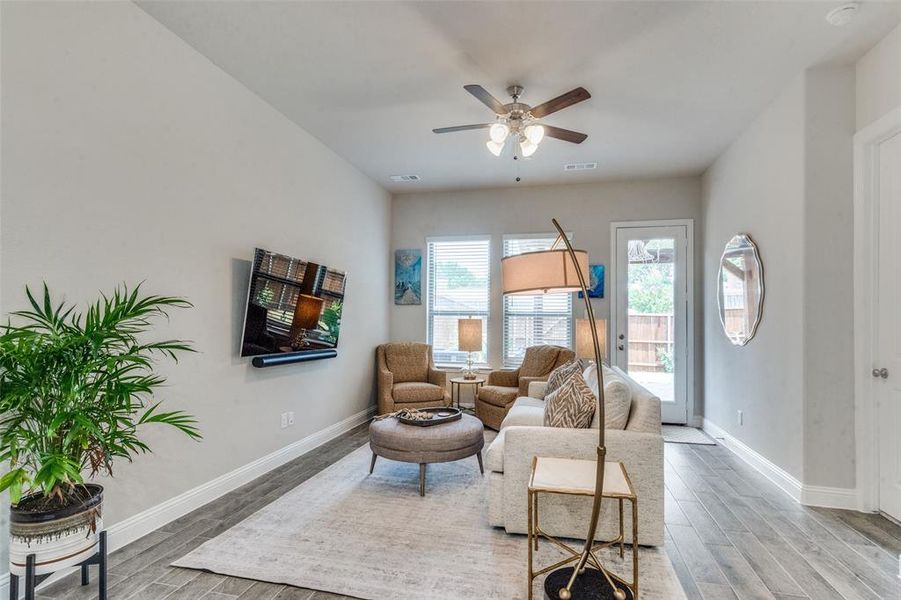 Sitting room featuring hardwood / wood-style flooring and ceiling fan