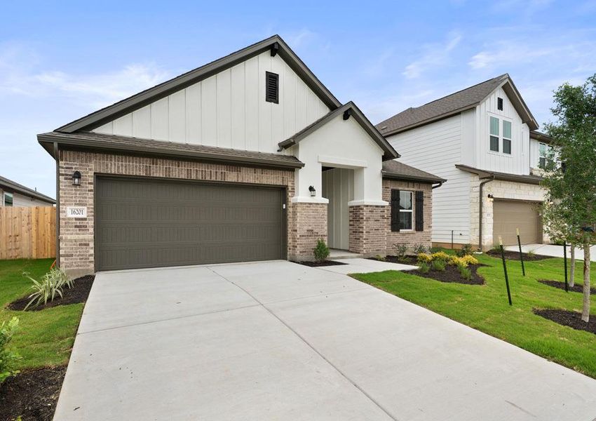 Front exterior of a new home in Lagos Reserve, Manor, TX, highlighting curb appeal (Image 2). Front exterior of a new home in Lagos Reserve, Manor, TX, highlighting curb appeal (Image 2).
