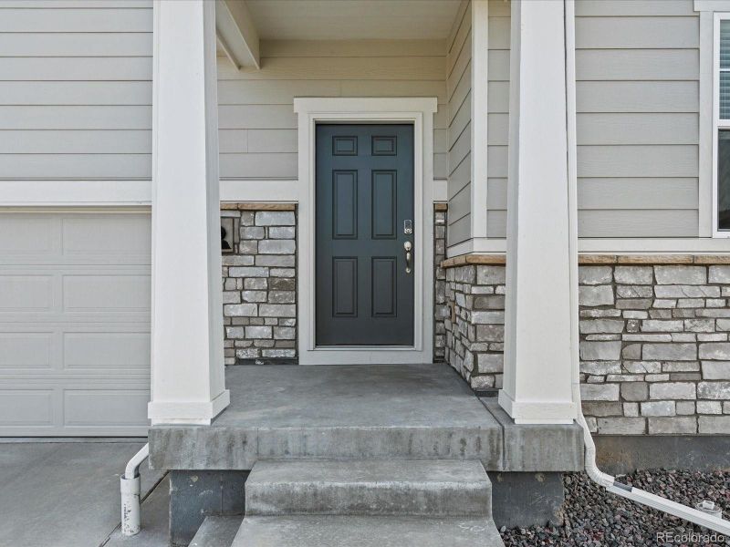 Front exterior of a new home in Revere at Johnstown, Johnstown, CO, highlighting curb appeal (Image 21). Front exterior of a new home in Revere at Johnstown, Johnstown, CO, highlighting curb appeal (Image 21).