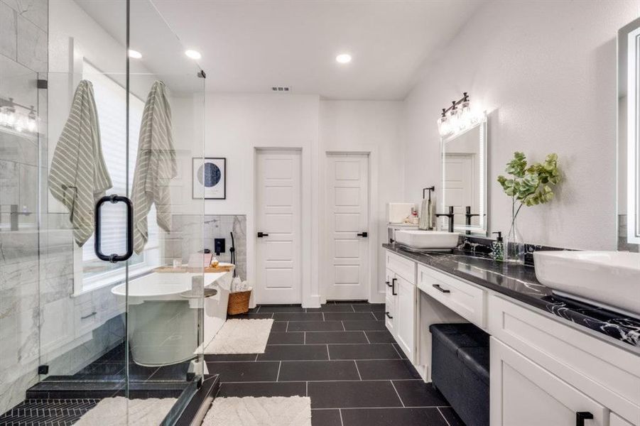 Bathroom featuring double vanity, a stall shower, tile patterned flooring, recessed lighting, and tile walls