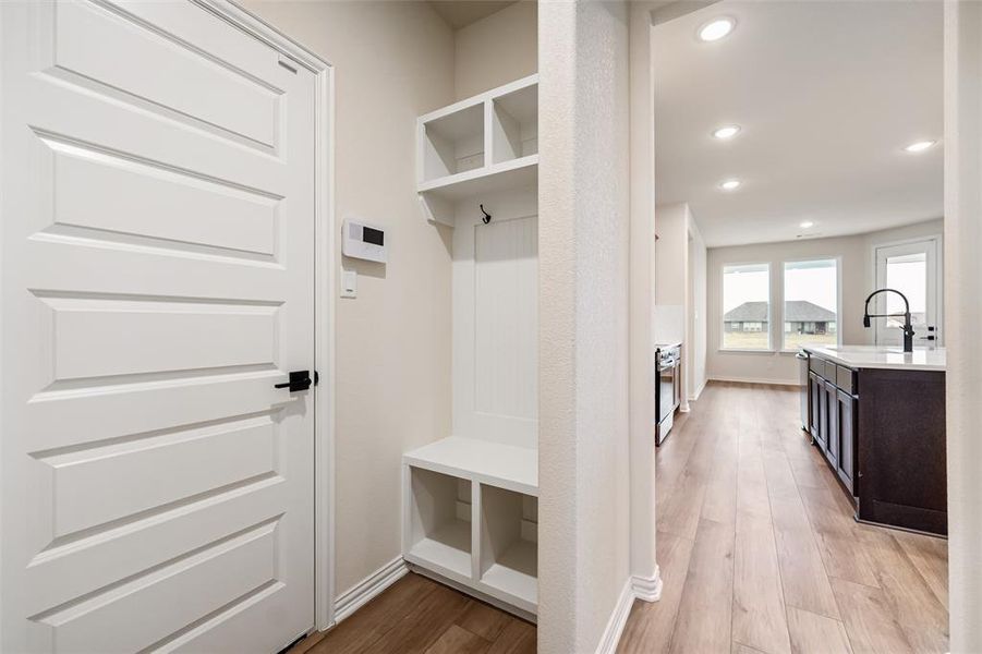 Mudroom featuring light wood-type flooring and recessed lighting
