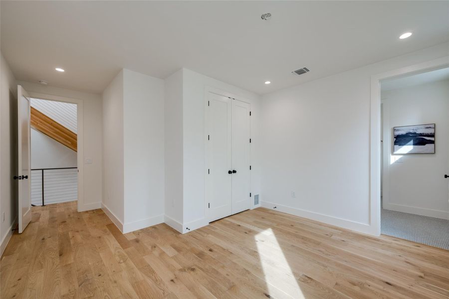 Living room featuring a wealth of natural light, light hardwood / wood-style flooring, and vaulted ceiling