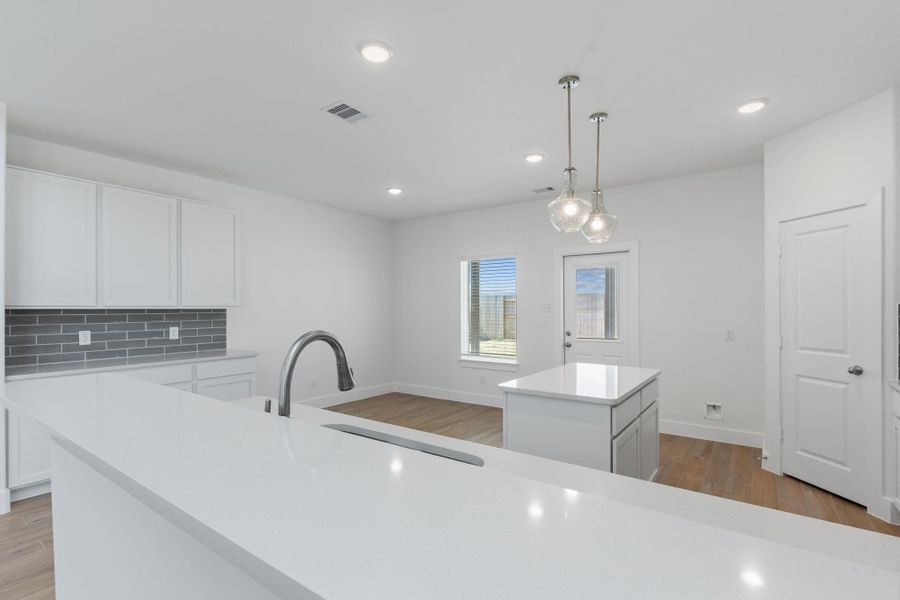 A chef’s dream kitchen featuring striking quartz countertops, stylish subway glass tile backsplash, and tall shaker cabinets. This modern space is as functional as it is beautiful! A chef’s dream kitchen featuring striking quartz countertops, stylish subway glass tile backsplash, and tall shaker cabinets. This modern space is as functional as it is beautiful!