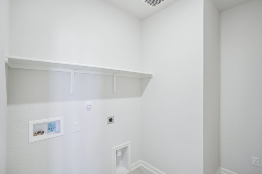 Laundry room in the Callaghan floorplan at a Meritage Homes community.