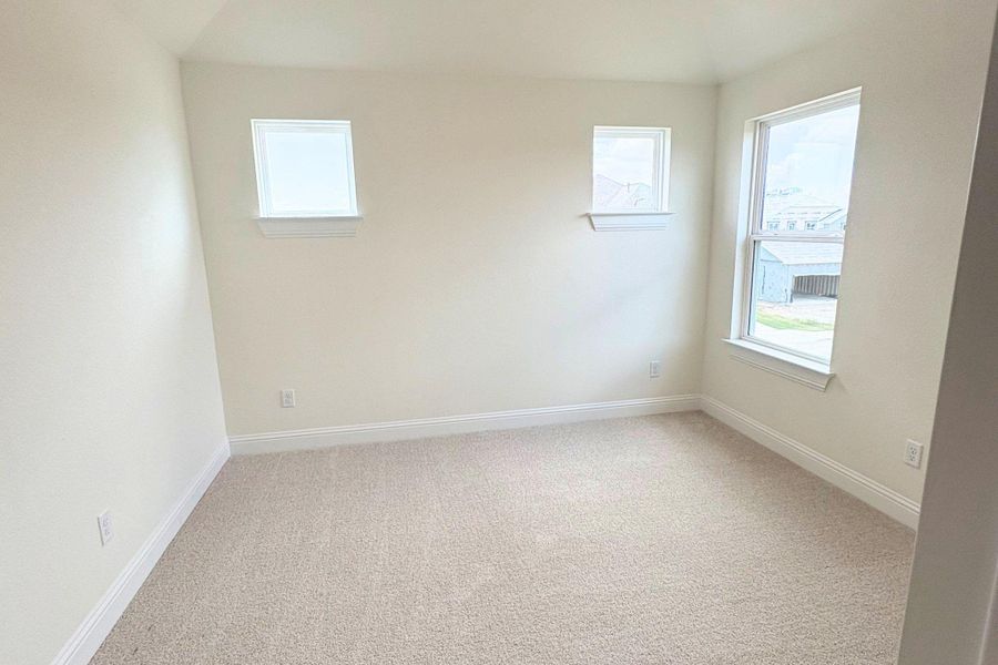 Crisp trimwork accents this cozy bedroom with soft plush carpeting and multiple windows. Crisp trimwork accents this cozy bedroom with soft plush carpeting and multiple windows.