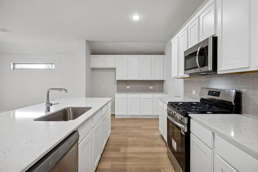 Kitchen in the Heisman home plan by Trophy Signature Homes – REPRESENTATIVE PHOTO