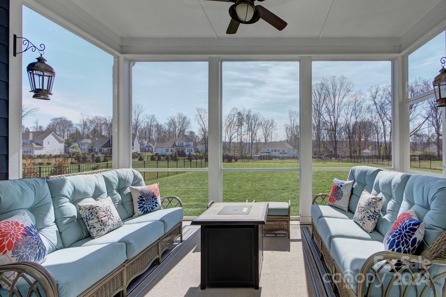 Screen porch overlooks large, flat fenced backyard.  Porch is TV ready ( bracket remains) and there are 12 foot panel sliding glass doors that open this space up to the great room