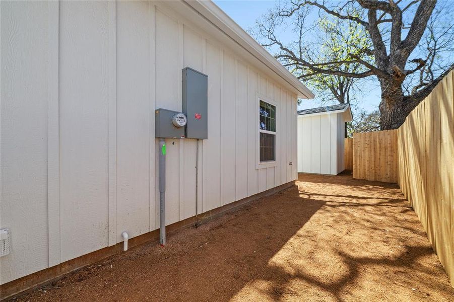 View of side of property with fence and board and batten siding View of side of property with fence and board and batten siding