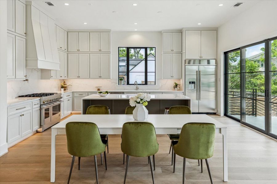 Gourmet Kitchen - features beautiful custom cabinetry and quartz counters. Custom sliding doors open to large covered back patio.