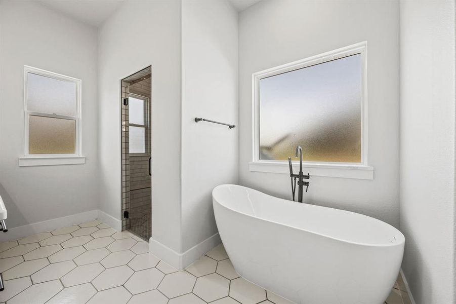 Full bathroom with a soaking tub and a shower stall Full bathroom with a soaking tub and a shower stall