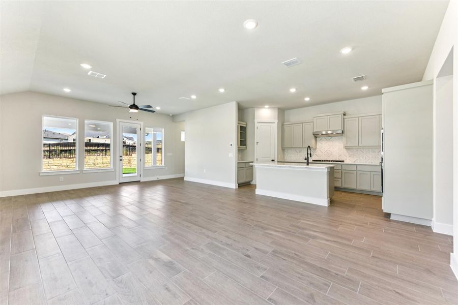 Unfurnished living room with recessed lighting, ceiling fan, and light wood-style flooring Unfurnished living room with recessed lighting, ceiling fan, and light wood-style flooring