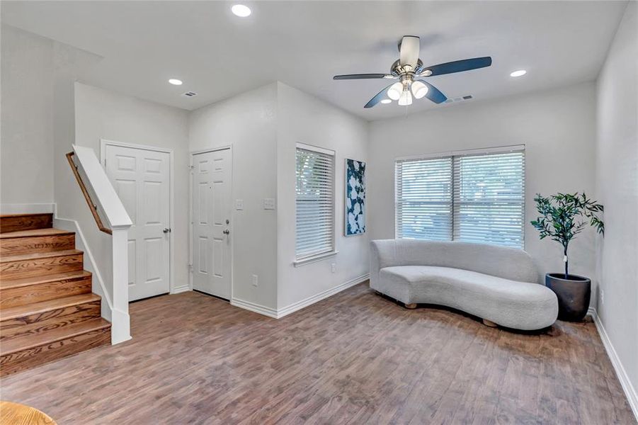 Sitting room with stairway, wood finished floors, recessed lighting, and ceiling fan Sitting room with stairway, wood finished floors, recessed lighting, and ceiling fan