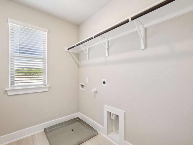 Laundry room in the Red River floorplan at a Meritage Homes community.