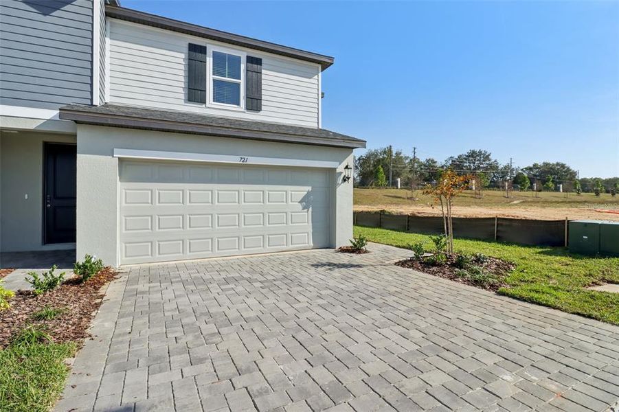 Exterior details and patio area of a home in The Reserve at Hammock Oaks Townes, Lady Lake (Image 3).