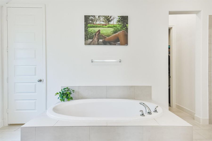 Large soaking tub is the centerpiece of this primary bath. Large soaking tub is the centerpiece of this primary bath.