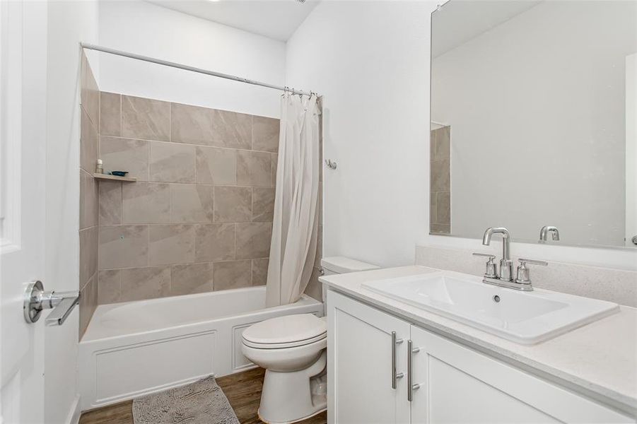 1st floor Bathroom featuring a white vanity with a rectangular undermount sink, a chrome two-handle faucet, and a large wall-mounted mirror
