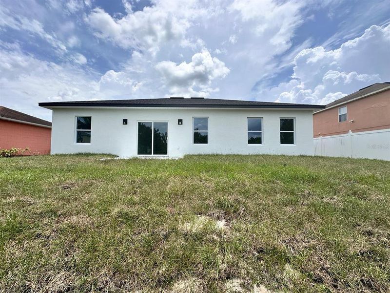 Front exterior of a new home in , Poinciana, FL, highlighting curb appeal (Image 2). Front exterior of a new home in , Poinciana, FL, highlighting curb appeal (Image 2).