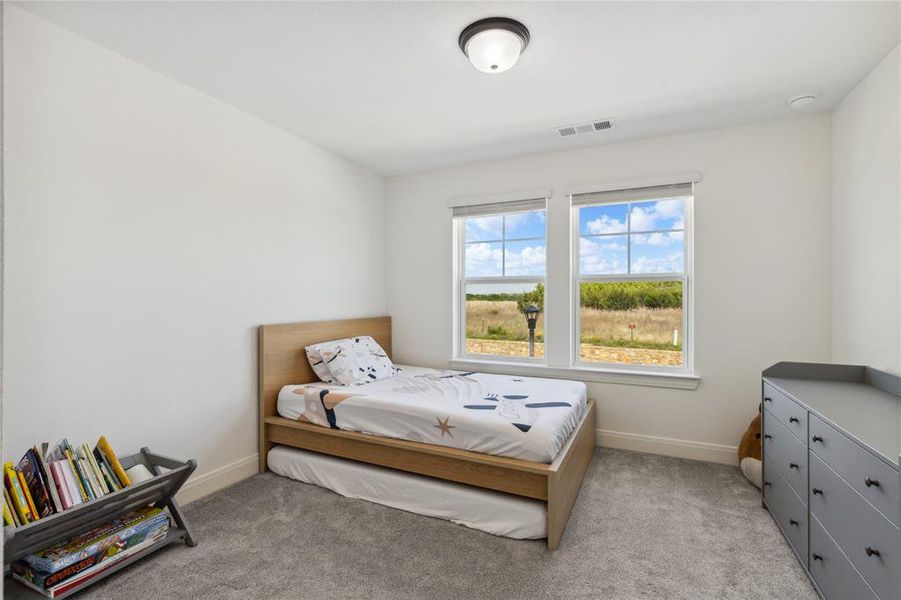 Bedroom with visible vents, baseboards, and light colored carpet Bedroom with visible vents, baseboards, and light colored carpet