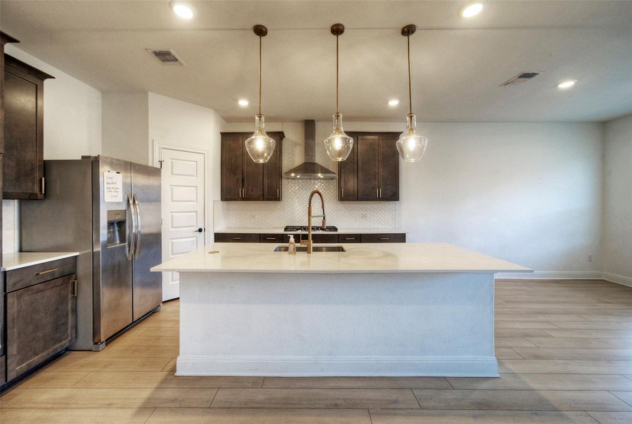 Smooth stone countertops and dark wood cabinetry anchor this modern, open-concept kitchen space. Smooth stone countertops and dark wood cabinetry anchor this modern, open-concept kitchen space.