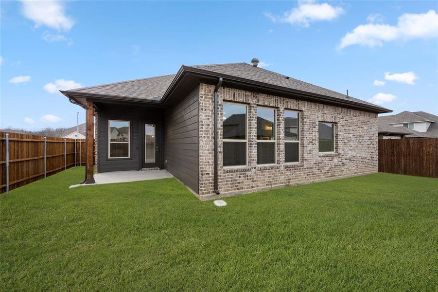 Back of house featuring a patio area, brick siding, and roof with shingles Back of house featuring a patio area, brick siding, and roof with shingles