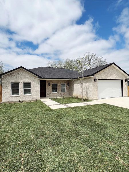 Ranch-style house with concrete driveway, an attached garage, a shingled roof, and a front yard Ranch-style house with concrete driveway, an attached garage, a shingled roof, and a front yard