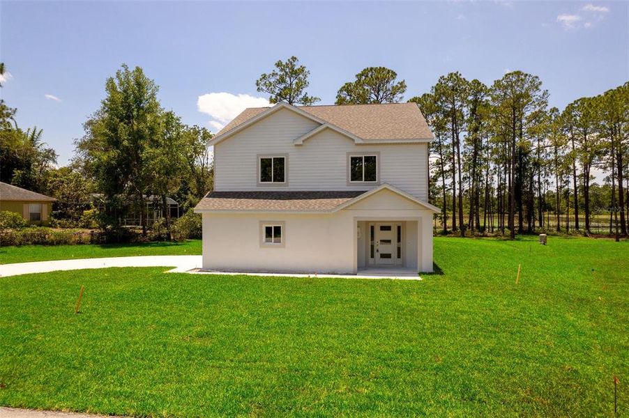 Front exterior of a new home in , Deltona, FL, highlighting curb appeal (Image 25).