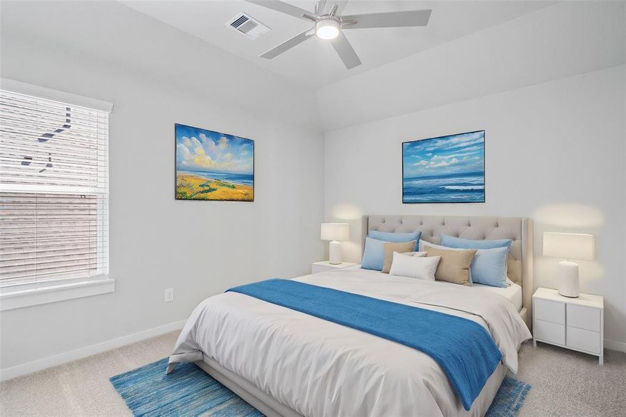 Secondary bedroom features plush carpet, custom paint, ceiling fan, and large window with privacy blinds.