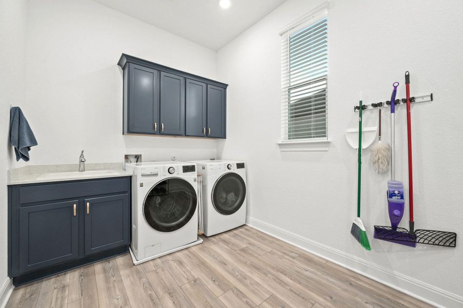 Big, bright, and functional-this laundry room makes everyday tasks easier with plenty of storage and a built-in sink Big, bright, and functional-this laundry room makes everyday tasks easier with plenty of storage and a built-in sink