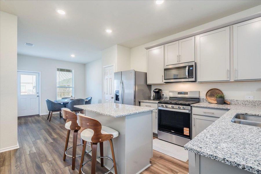 Kitchen features stainless appliances, center island, granite counters, LVP and recessed lighting Kitchen features stainless appliances, center island, granite counters, LVP and recessed lighting
