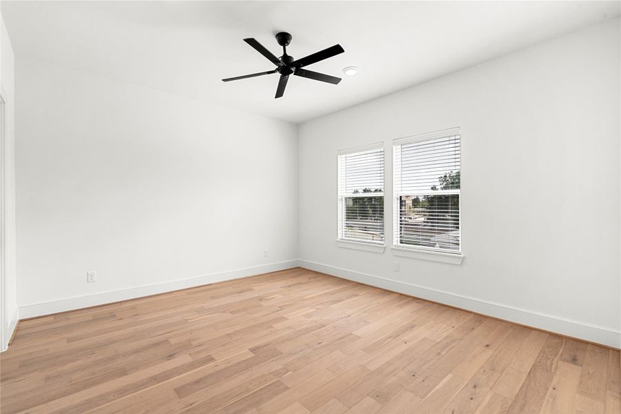 Third floor secondary bedroom offers ton of natural light with two windows.