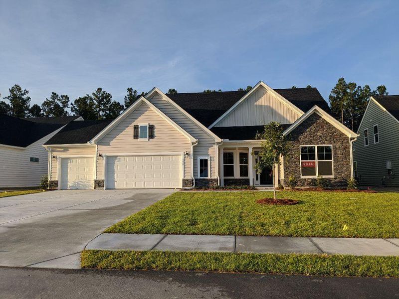 Front exterior of a new home in The Enclave at French Quarter Creek, Huger, SC, highlighting curb appeal (Image 1). Front exterior of a new home in The Enclave at French Quarter Creek, Huger, SC, highlighting curb appeal (Image 1).