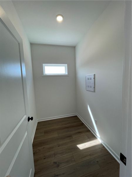 This interior hallway features sleek hardwood floo