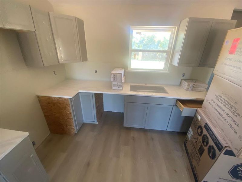 Kitchen featuring white fridge and dark wood finished floors Kitchen featuring white fridge and dark wood finished floors