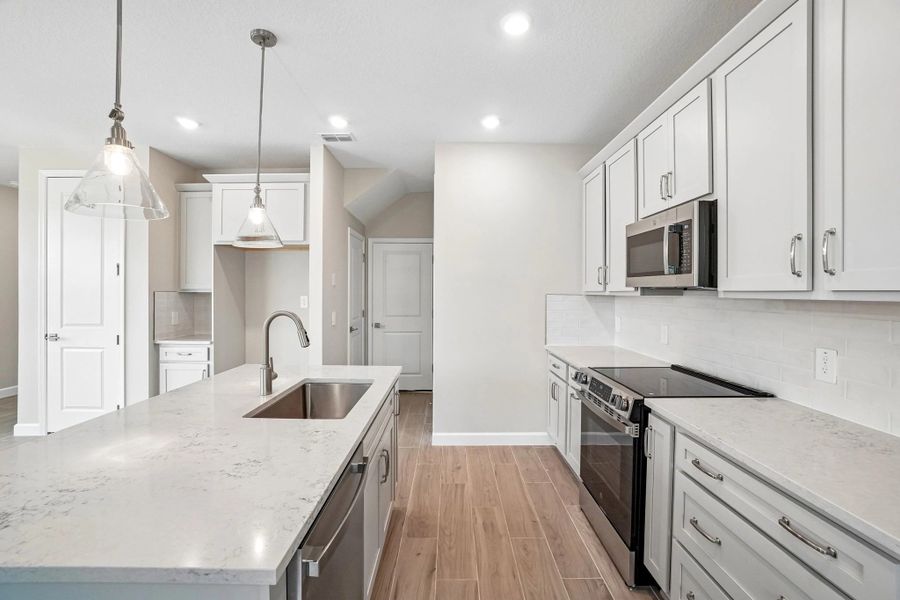 The kitchen features a large island and a spacious layout