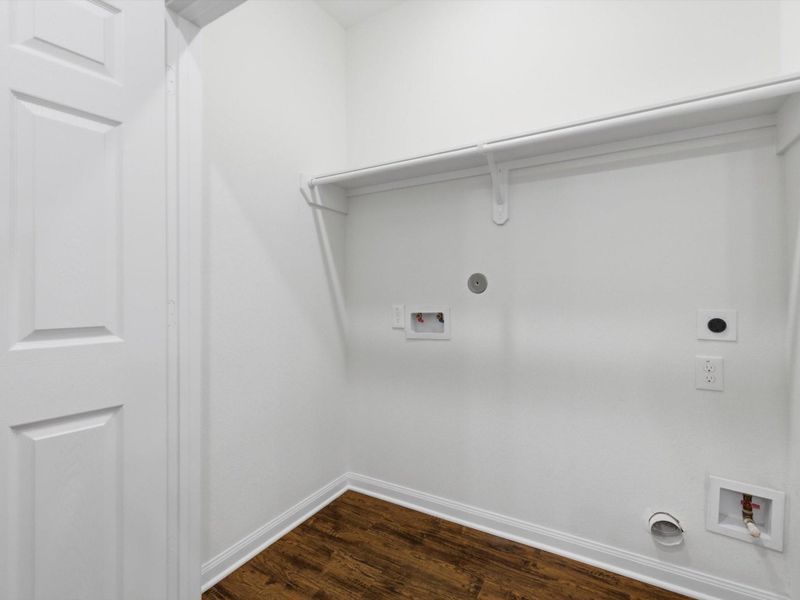 Thoughtfully positioned for everyday convenience, the utility room offers a dedicated space for laundry and household organization.