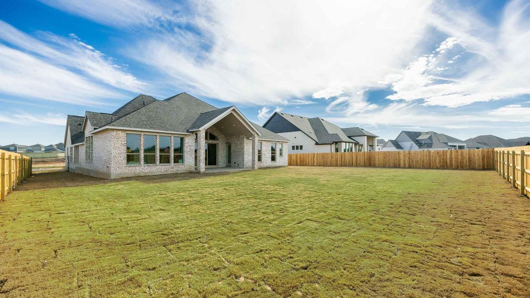 Rear view of house featuring a fenced backyard, a residential view, a shingled roof, and a lawn Rear view of house featuring a fenced backyard, a residential view, a shingled roof, and a lawn