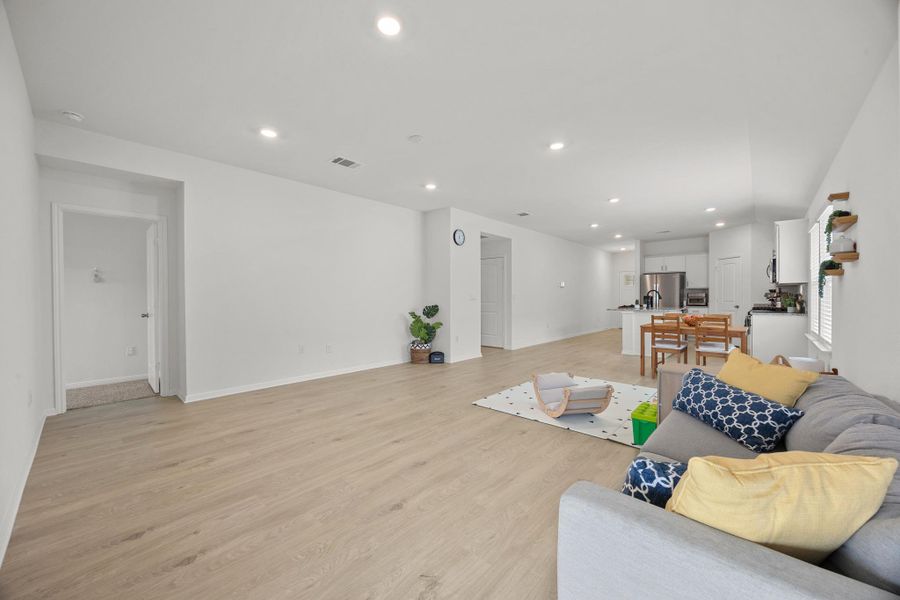 Living area with recessed lighting and light wood finished floors