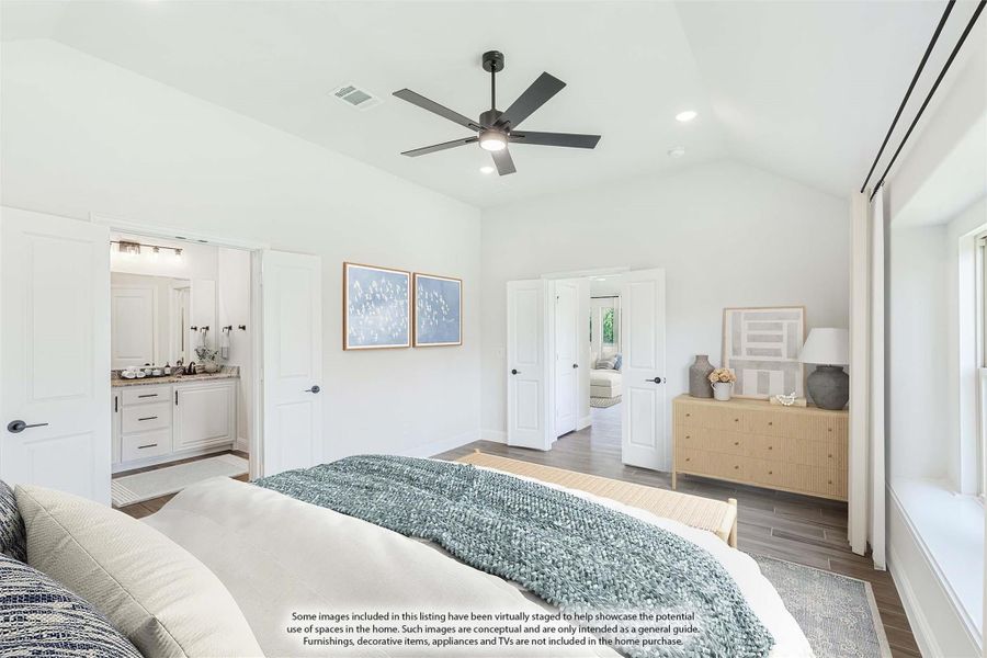 Master bedroom with vaulted ceiling, ceiling fan, hardwood floors, and ensuite bathroom visible through open door.