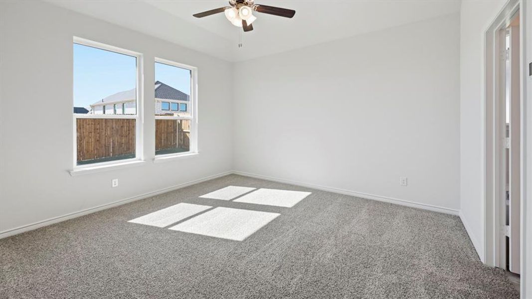 Room featuring light gray carpeting, crisp white walls, two large windows, and a ceiling fan with integrated lighting Room featuring light gray carpeting, crisp white walls, two large windows, and a ceiling fan with integrated lighting