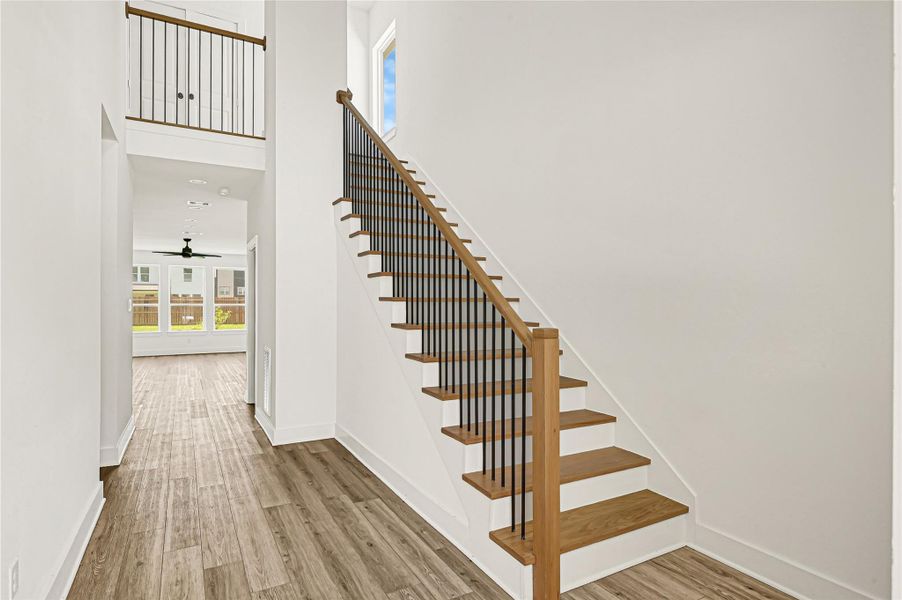 Bright foyer featuring an elegant staircase and welcoming interior design. Bright foyer featuring an elegant staircase and welcoming interior design.