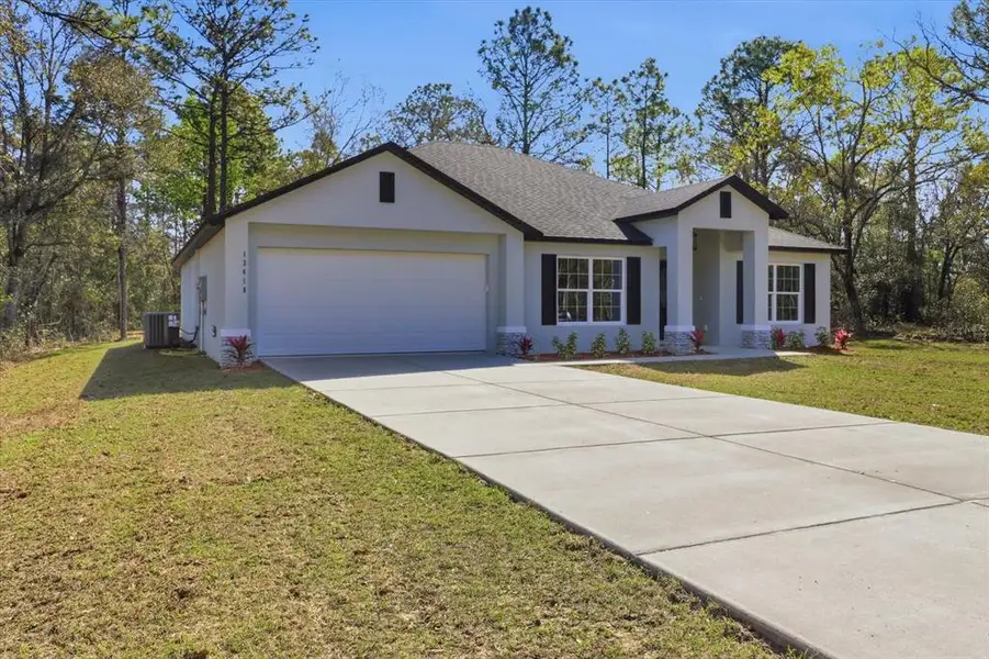 Front exterior of a new home in , Weeki Wachee, FL, highlighting curb appeal (Image 20).