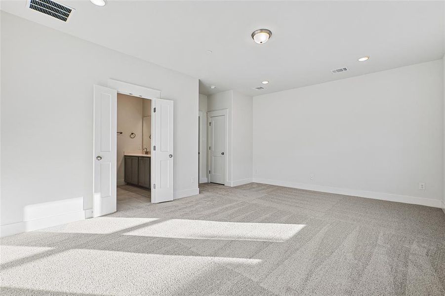 Spare room featuring light carpet and recessed lighting