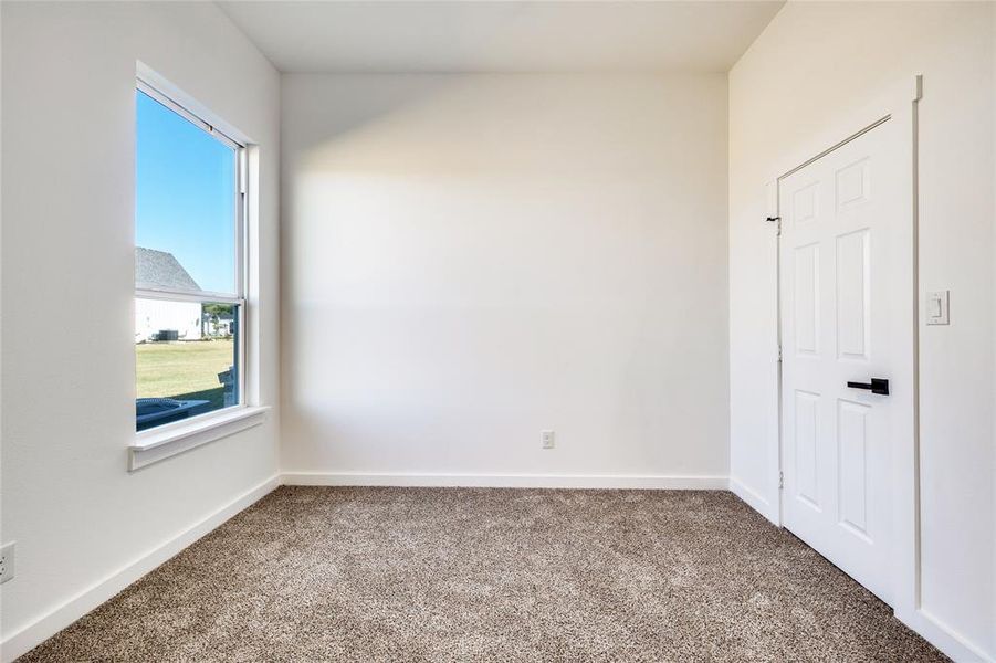 Unfurnished room with carpet flooring and baseboards