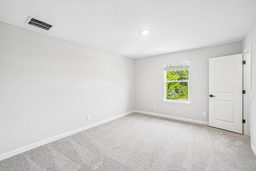 Bedroom 4 is located on the other side of the stairs and features a walk-in closet Bedroom 4 is located on the other side of the stairs and features a walk-in closet