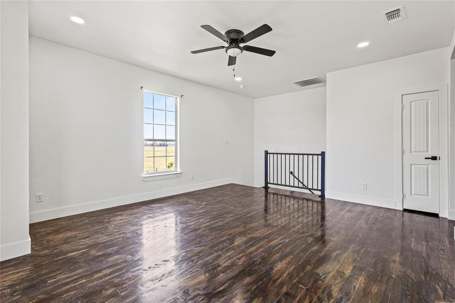 Spare room featuring dark wood-style flooring, recessed lighting, and a ceiling fan Spare room featuring dark wood-style flooring, recessed lighting, and a ceiling fan