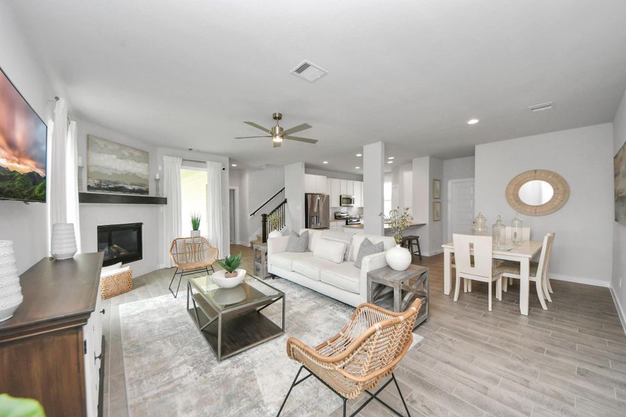 Relax and unwind in this inviting family room, illuminated by abundant natural light streaming in through tall windows, complemented by high ceilings and stunning flooring. Relax and unwind in this inviting family room, illuminated by abundant natural light streaming in through tall windows, complemented by high ceilings and stunning flooring.