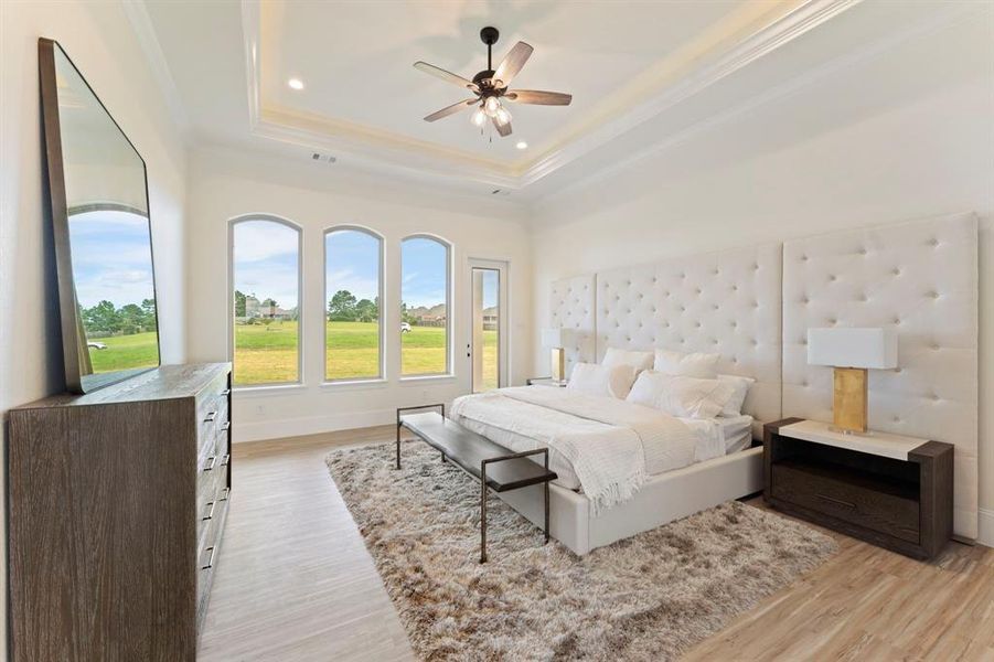 The owner's suite is breathtaking with trayed lighted ceilings, walls of windows, and access to your own patio. The gorgeous bed from Star Furniture is The King Brando Wall Bed (KT:65375)