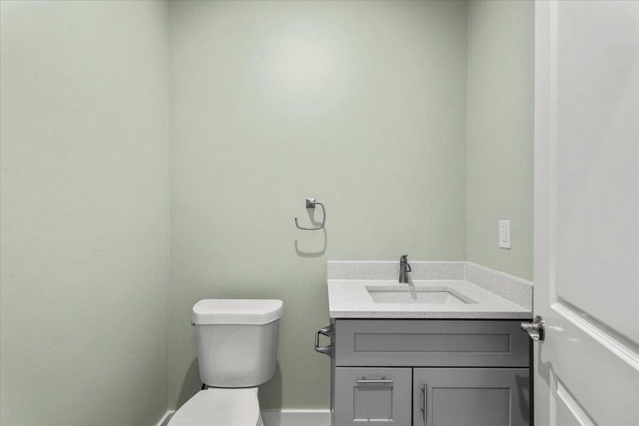 Half bath with vanity and toilet