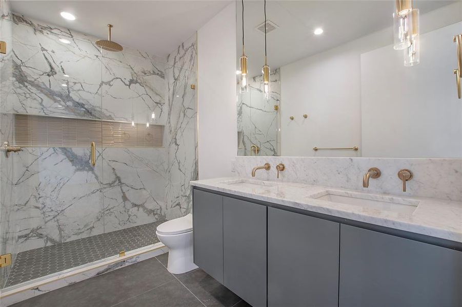 Bathroom with tile patterned flooring, vanity, toilet, and a shower with shower door